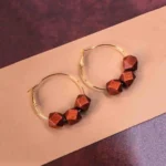 Chic metal hoop earrings featuring a wooden beads and a latch back for easy wear