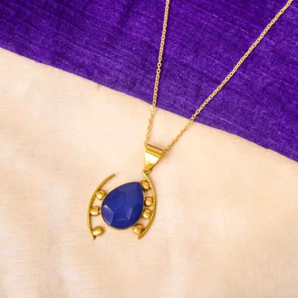 Stylish metal curb chain necklace with an organic-shaped pendant, enhanced with faceted blue teardrop stones, having a polished gold-tone finish, and a secure lobster claw clasp