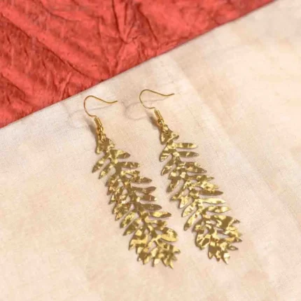 Sophisticated gold stud dangle earrings featuring a teardrop-shaped acrylic drop in a marbled blend of white and blue, secured with a push-back closure.