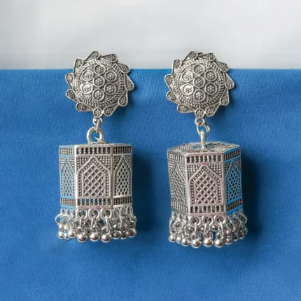 Lovely antique-finish oxidised metal jhumka earrings with a floral design, delicate dangling metallic beads, a classic hexagonal design, ghungroo at the end and a push-back closure