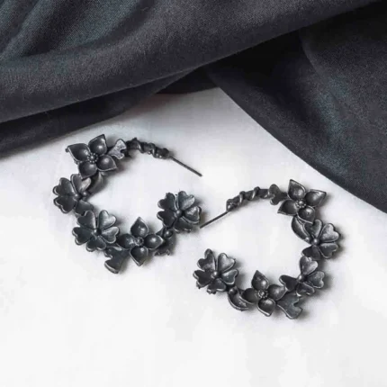 Intricately crafted oxidized C-hoop earring with floral detailing, offering a vintage charm, and finished with a push-back closure.