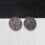 Vintage-inspired oxidized gold-tone circular dangle earring with a textured floral motif, flowing chain tassels, and a comfortable curved hook.