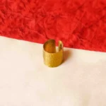 Elegant gold-tone ring featuring a cylindrical shape having a open-end design, and fine moulded texture with complex details