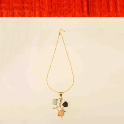 Stylish metal curb chain necklace with an organic-shaped pendant, enhanced with faceted blue teardrop stones, having a polished gold-tone finish, and a secure lobster claw clasp