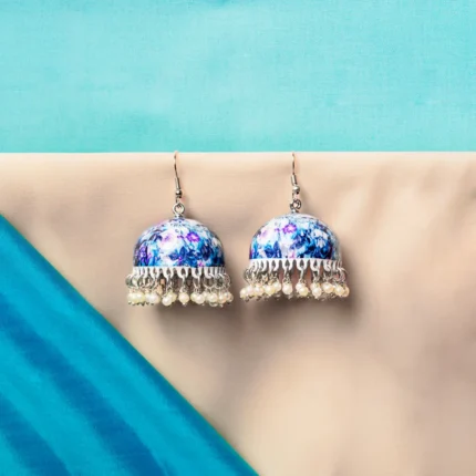 Elegant silver-finish jhumka earring with butterfly meenakari artwork, a detailed circular top, pearl bead accents, and a secure push-back closure.