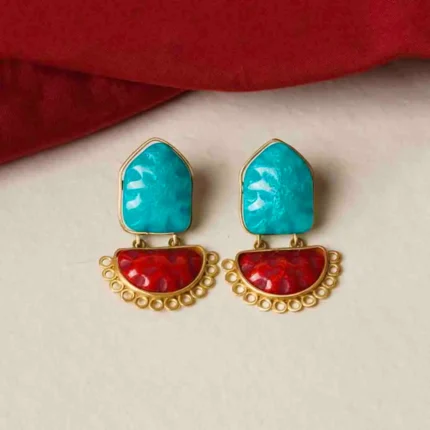 Modern brass drop earring with a sculptural design, showcasing an triangular-shaped top with a hollow center, two interlinked hoops, and a textured triangle charm gracefully dangling at the bottom, secured with a push-back closure