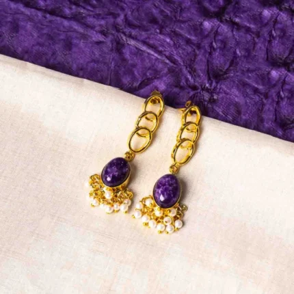 Elegant metal drop earrings in a polished gold, dark pink, and pearl white finish, showcasing overlapped oval links, a purple marble-textured stone, and delicate dangling pearls, finished with a push-back closure.