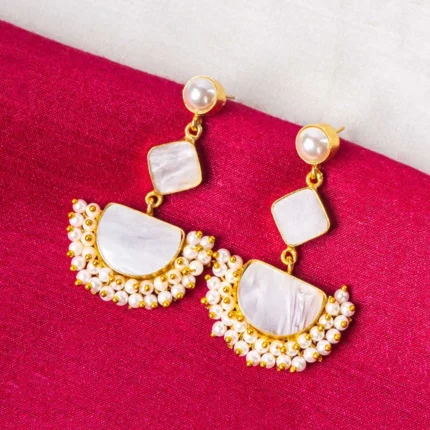 Statement geometric dangle earrings in a polished gold and pearl white finish, designed with a pearl top, an inverted square detail, a crescent-shaped base, and white enamel with pearl bead accents, completed with a push-back closure.