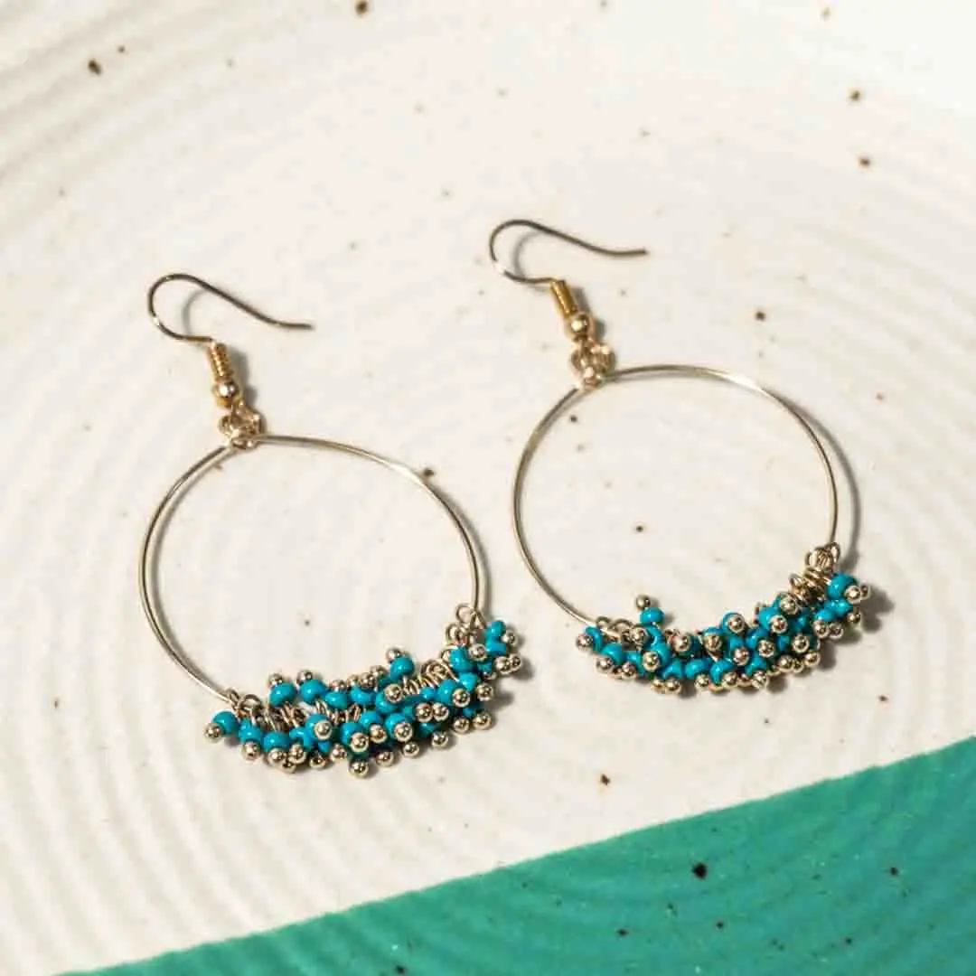 153-Th Chic octagonal hoop earrings featuring a polished gold-tone finish, playful blue gemstone ,colorful beaded accents, and a push back for easy wear.