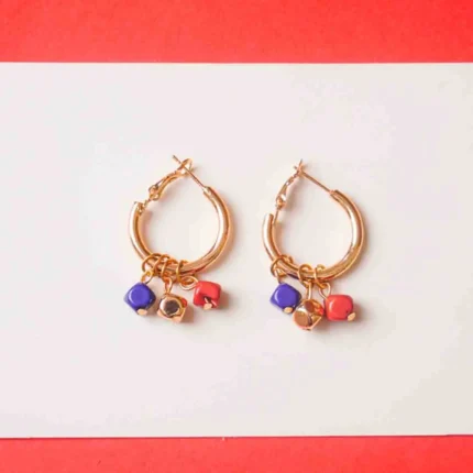 Chic metal hoop earrings featuring a polished gold-toneburnt umber finish featuring golden blue and brick coloured mini cube shaped chrams at the bottom, and a hinged back for easy wear.