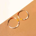 Trendy mini C-hoop earring with accents of brown,cream,orange shades and push-back post.
