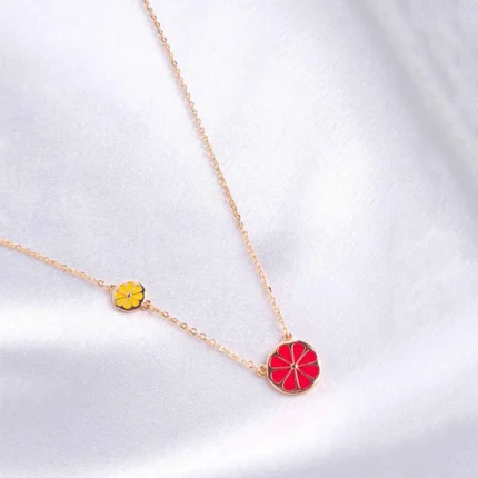 Stylish gold-tone necklace with a filled flat cable chain, lime yellow finish featuring enamel coated red coloured flower in the middle with a small yellow coloured flower , and a lobster claw clasp.