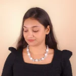 Elegant beaded necklace with a gold-tone/grey finish, featuring round grey beads and a secure lobster claw clasp