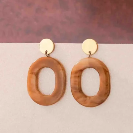 Chic oval resin drop earrings with a sleek geometric design, accented by a gold-tone top and finished with a push-back closure.
