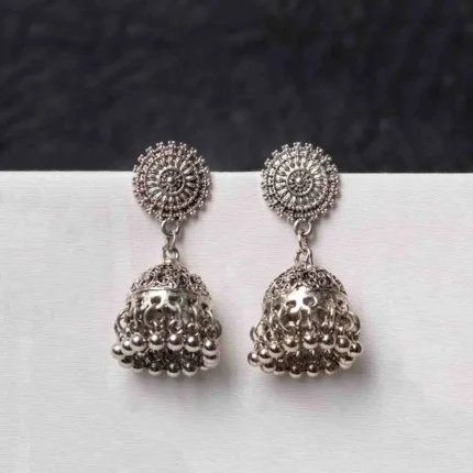 Traditional oxidized silver jhumka earring featuring fine intricate detailing, a floral-designed top, and a secure push-back closure