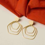 Contemporary brass earring with an intricate geometric design of three overlapping hexagon-shaped spheres, a crescent accent on top, and a push-back closure for comfort