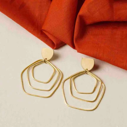 Contemporary brass earring with an intricate geometric design of three overlapping hexagon-shaped spheres, a crescent accent on top, and a push-back closure for comfort