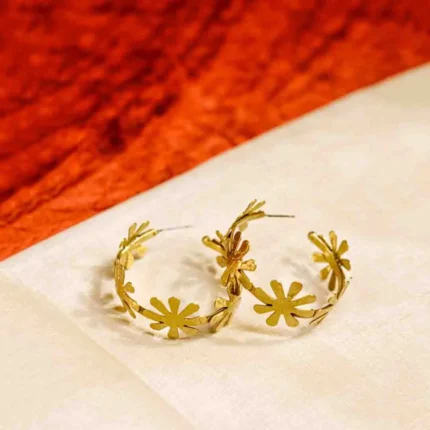 C-hoop brass earring with a continuous floral pattern and a secure push-back closure