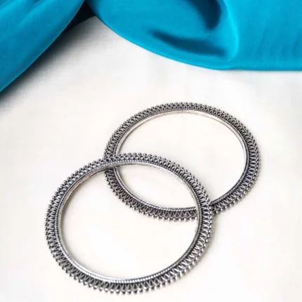 Antique-inspired oxidized silver-tone bangle set with finely detailed lines and circular metallic beaded designs