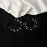 Delicately designed oxidized silver C hoop earring adorned with dangling ghungroos and finished with a push-back closure
