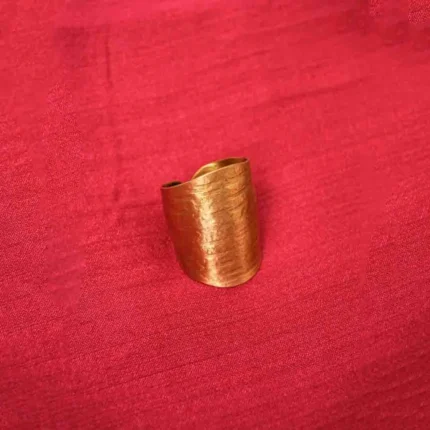 C-hoop brass earring with a continuous floral pattern and a secure push-back closure