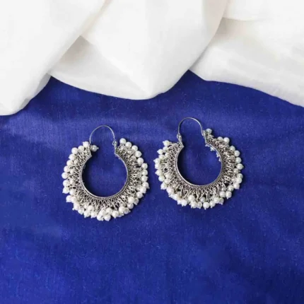 Classic oxidized silver hoop earring with an open-end design, detailed carvings, and dainty pearl beads, secured with a hinged back closure.