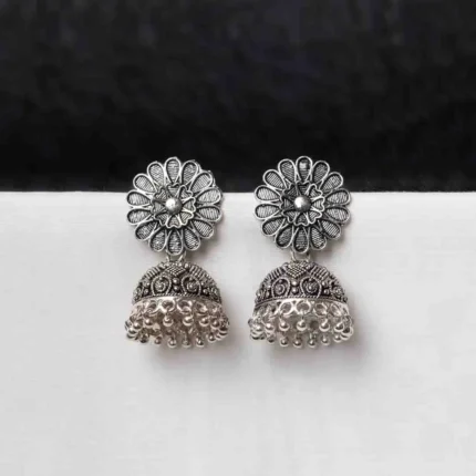 Oxidised jhumka earrings with complex floral detailing, featuring a finely detailed floral top, delicate detailing, and ghungroos at the bottom, secured with a push-back closure