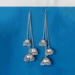 Statement silver tassel earrings featuring a delicately engraved design, long chain tassels for an elegant dangle effect with jhumkas and ghungroos at the end, and a curved hook feature