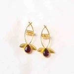 Charming oxidized silver-tone floral dangling earring with delicate detailing, red-colored teadrop shaped stones, two- textured leaves at the bottom, and a push-back post for a secure fit.