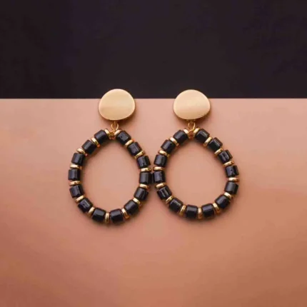 Sleek and contemporary dangle earrings with a coiled spiral structure, finished in a silver tone and secured with a push-back post.