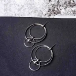 Sophisticated silver-toned hoop earring featuring a geometric double-hoop structure, a dainty dangling sphere, and a push-back fastening