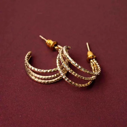 Stylish three-tier c hoop earrings with a golden/silver-tone finish, pink bead accents, and a push back closure.