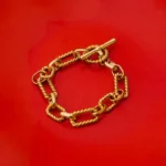 Sleek twisted spiral gold-tone bracelet crafted from metal gauge wire, finished with a classic toggle clasp