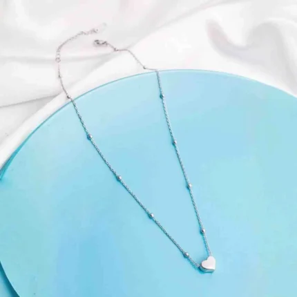 Minimalist satellite chain necklace with a polished silver-tone finish and a central solid heart pendant