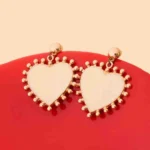 Elegant dangling earrings featuring enamel detailing framed with small beads and a push back closure.