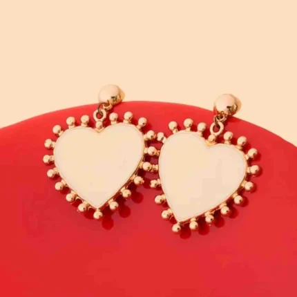 Elegant dangling earrings featuring enamel detailing framed with small beads and a push back closure.