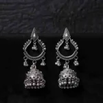 Oxidised jhumka earrings with complex floral detailing, featuring a finely detailed teardrop-shaped top, dangling circular beads, and ghungroos at the bottom, secured with a push-back closure.