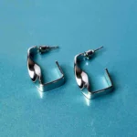 Fashion-forward silver-tone drop earrings featuring a sculptural asymmetrical spiral twist design, secured with a classic push-back closure