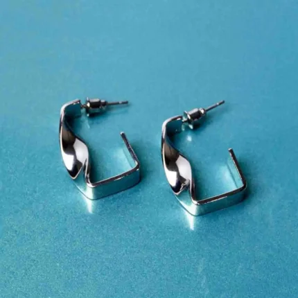 Fashion-forward silver-tone drop earrings featuring a sculptural asymmetrical spiral twist design, secured with a classic push-back closure