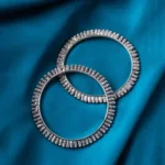 Antique-inspired oxidized silver-tone bangle set with cylindrical patterns with fine delicate detailing.