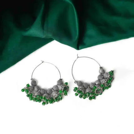 Classic silver-tone hoop earring designed with circular beads, dangling jhumkas, and small bead embellishments at the edges for a traditional appeal.