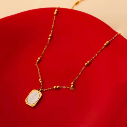 Minimalist gold-tone bracelet with a fine satellite chain, a sleek curved rectangular bar, and a petite orange heart charm, finished with a secure lobster claw clasp.