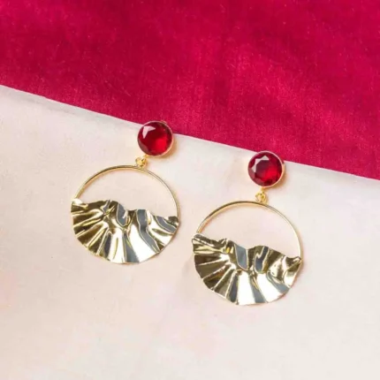 Trendy gold-tone/navy blue hoop earring with a hammered finish, layered hoop design, blue dangling circular beads, and a striking blue stone on top, fastened with a push-back closure.