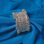 Oxidized silver-tone metal cuff bracelet featuring fine intricate detailing and adorned with ghungroos on both edges.