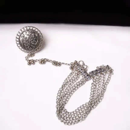 Elegant oxidised silver-tone bracelet with a ring design, adorned with fine delicate floral detailing with chain tassels and finished with an S-hook closure.