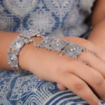 Elegant oxidised silver-tone bracelet with a ring design, adorned with fine intricate patterns and finished with an S-hook closure.