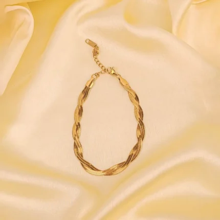 Elegant adjustable curb chain bracelet in a gold-tone finish, featuring a curved metallic wire centerpiece with a dangling spherical charm and a secure spring ring clasp.