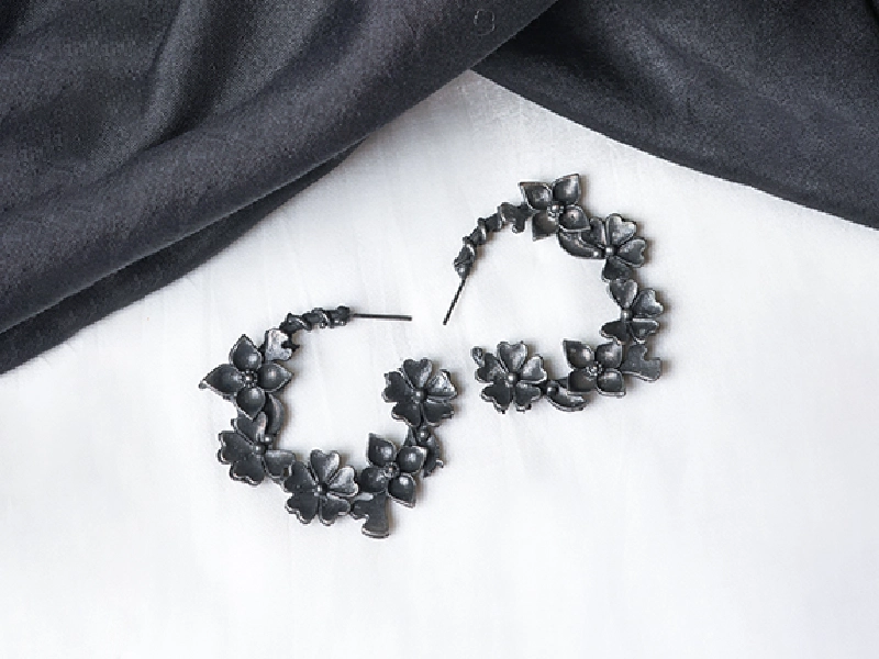 Elegant flatlay of oxidised jewelry including layered necklaces, jhumkas, bangles, and rings styled with ethnic and Western outfits – perfect for every occasion1