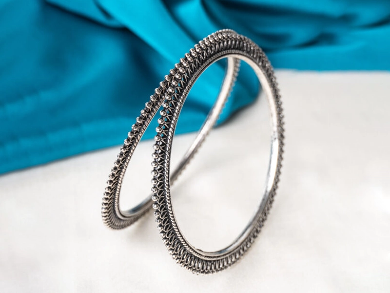 Elegant flatlay of oxidised jewelry including layered necklaces, jhumkas, bangles, and rings styled with ethnic and Western outfits – perfect for every occasion 14