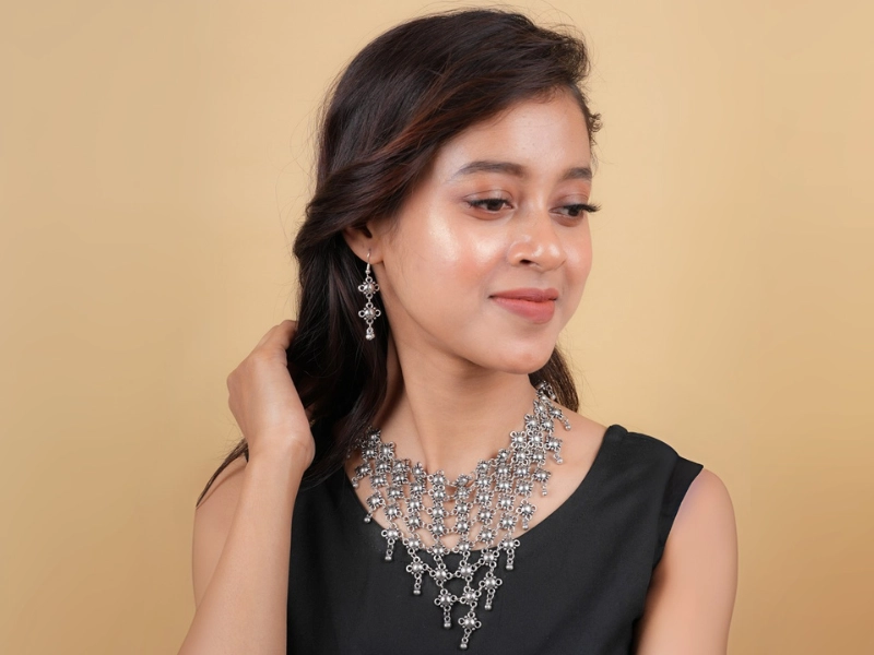 Elegant flatlay of oxidised jewelry including layered necklaces, jhumkas, bangles, and rings styled with ethnic and Western outfits – perfect for every occasion 18